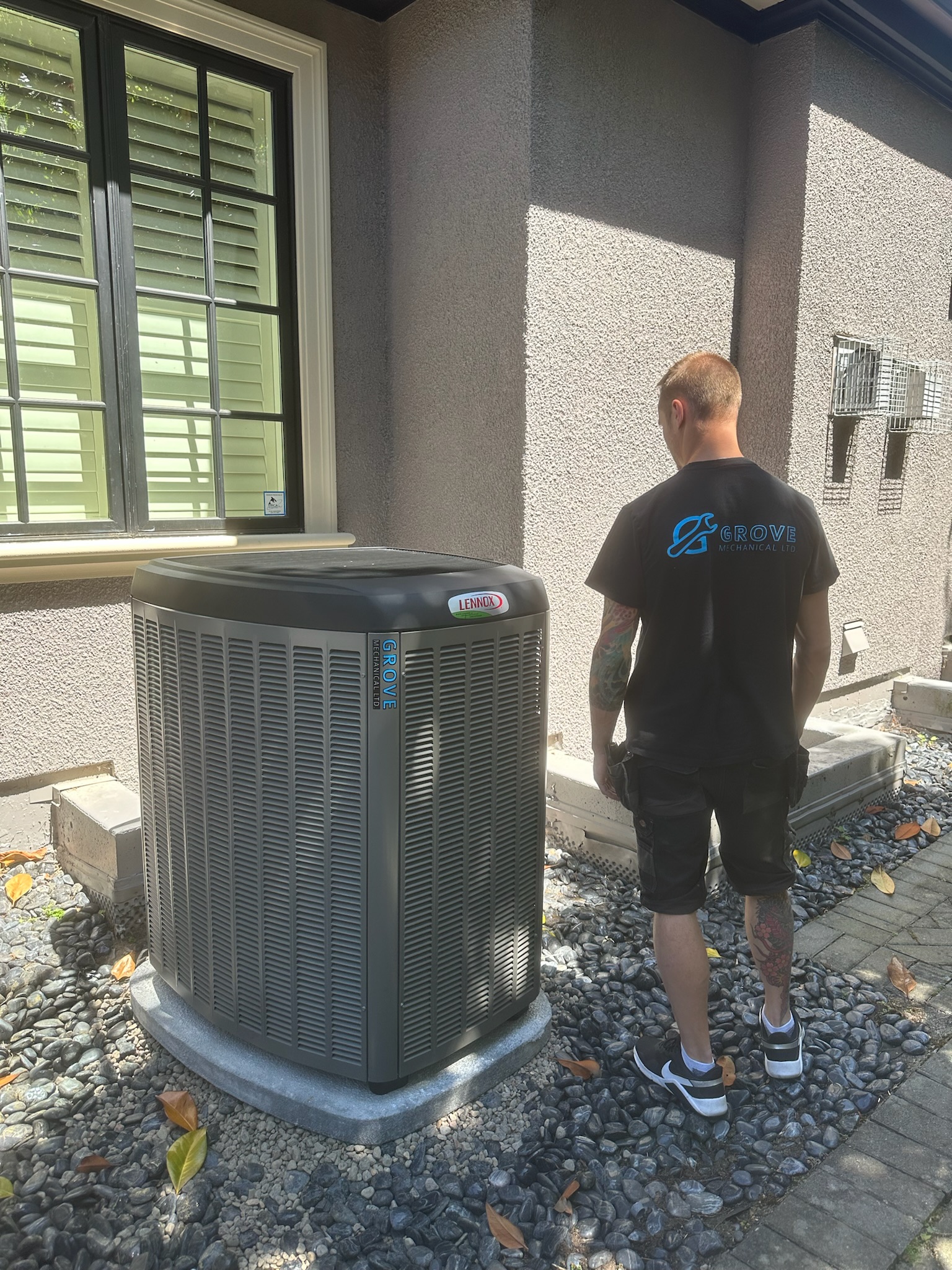 Grove Mechanical technician inspecting Lennox AC unit