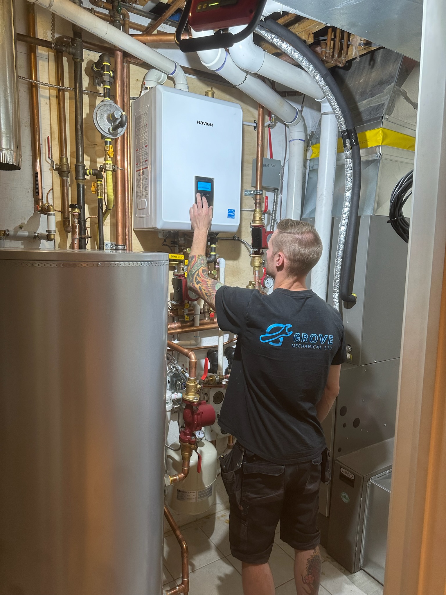 Grove technician programming Navien boiler with hot water tank