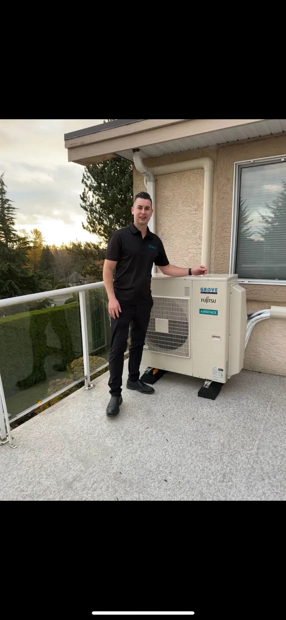 Grove Mechanical owner standing next to Fujitsu Airstage heat pump