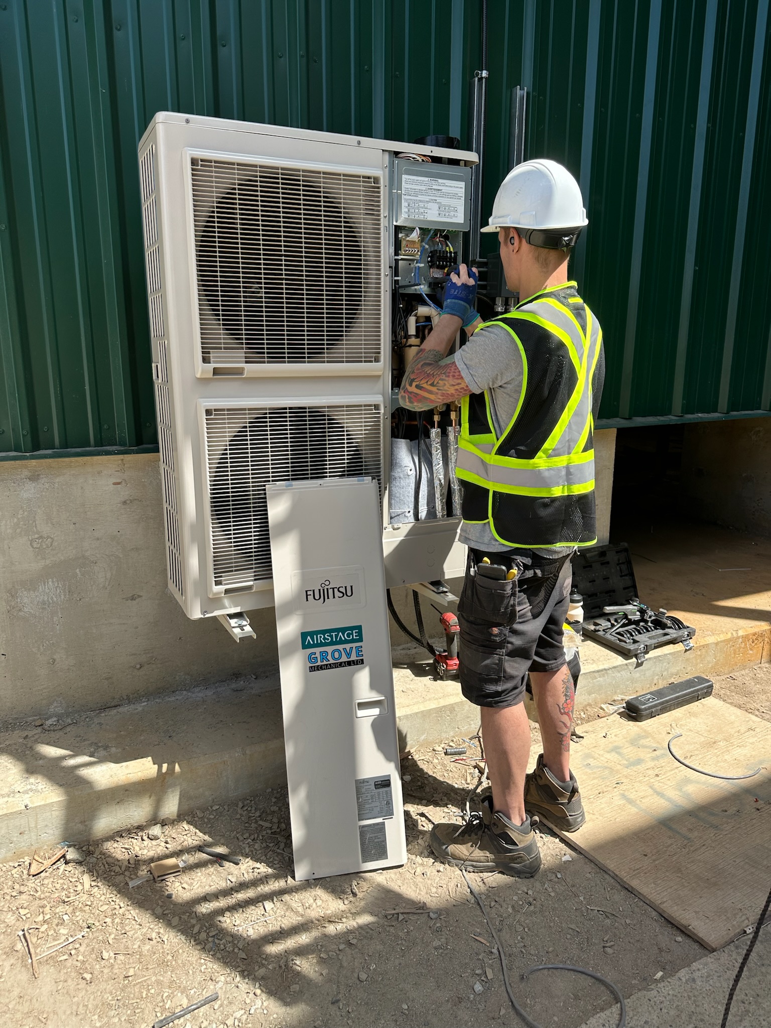 Grove Mechanical technician installing Fujitsu heat pump system