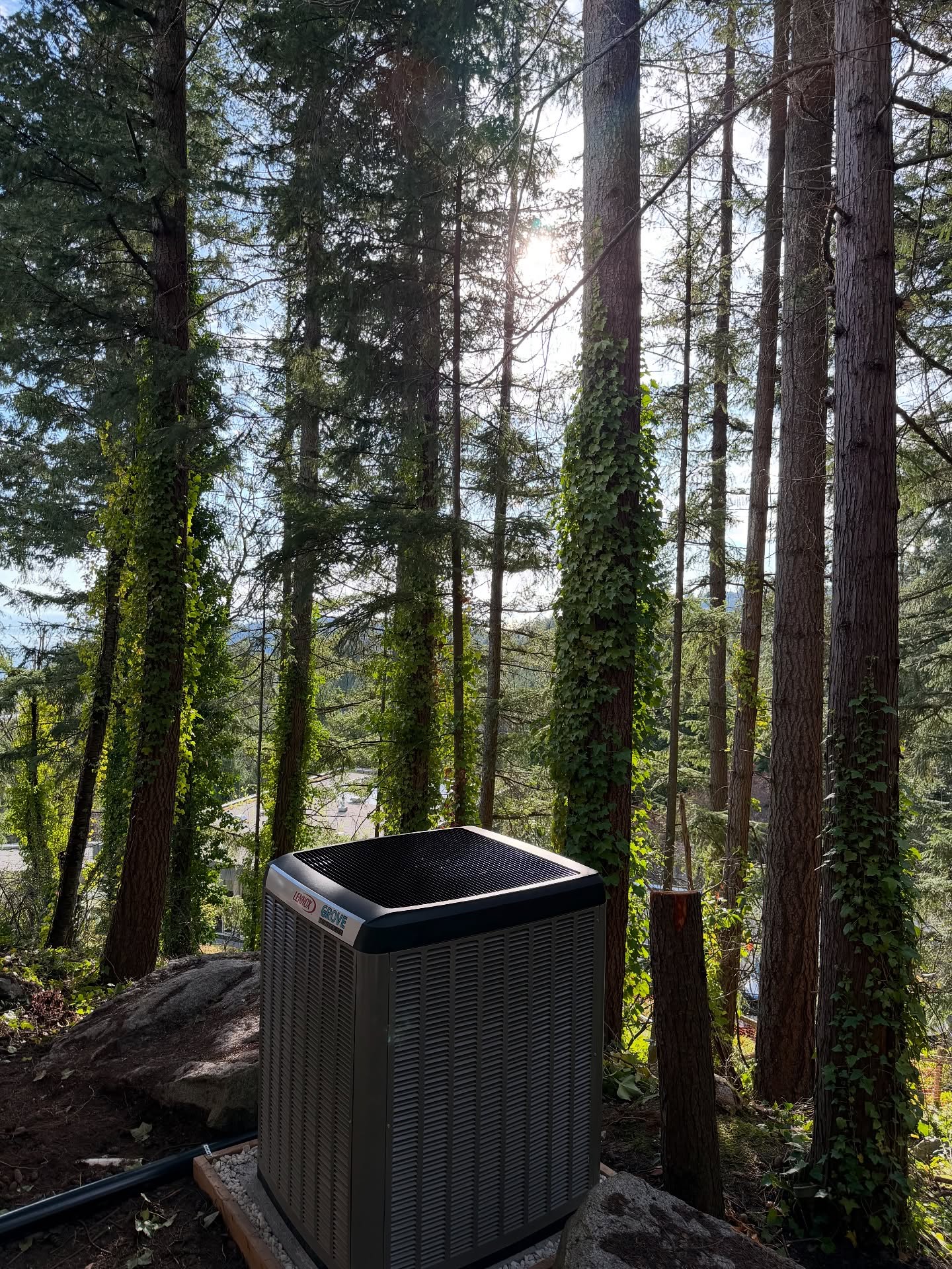 Grove technician servicing outdoor AC unit with refrigerant gauges