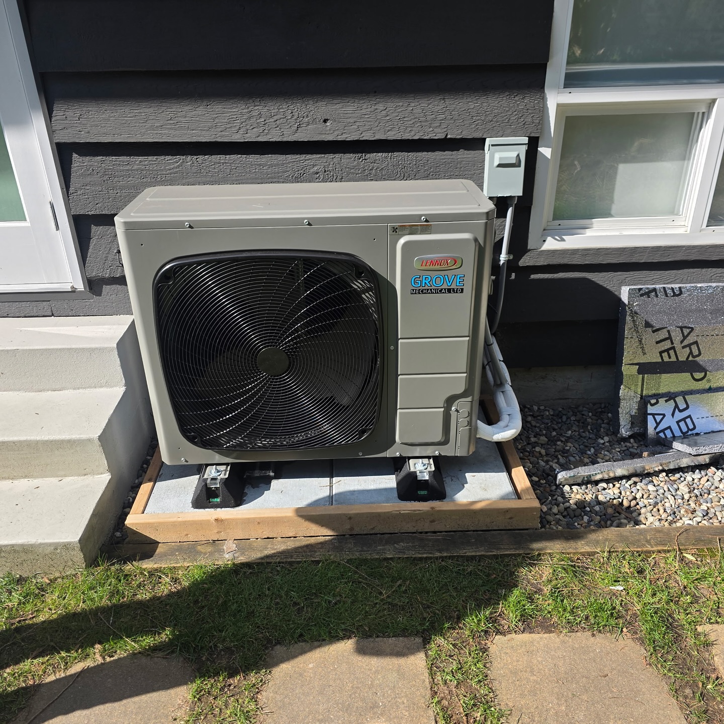 Fujitsu Airstage outdoor units installed on blue house